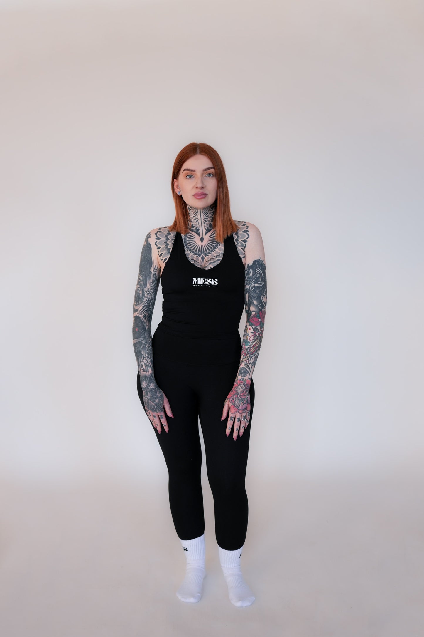 Model wearing the obsidian obsession tank top MESB set and white MESB socks
