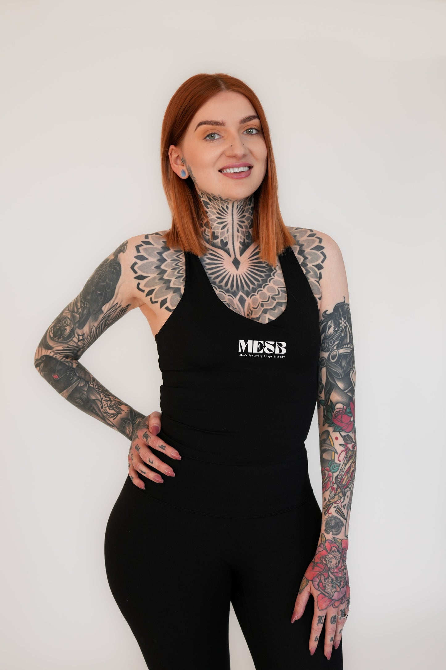 Close up of model wearing Obsidian obsession tank top MESB set with her hand on her hip